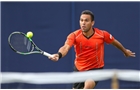 EASTBOURNE, ENGLAND - JUNE 14: Victor Estrella Bugos of the Dominican Republic plays a backhand against James Marsalek of Great Britain during their Men's Singles second round qualifying match on day one of the Aegon International at Devonshire Park on June 14, 2014 in Eastbourne, England.  (Photo by Steve Bardens/Getty Images)